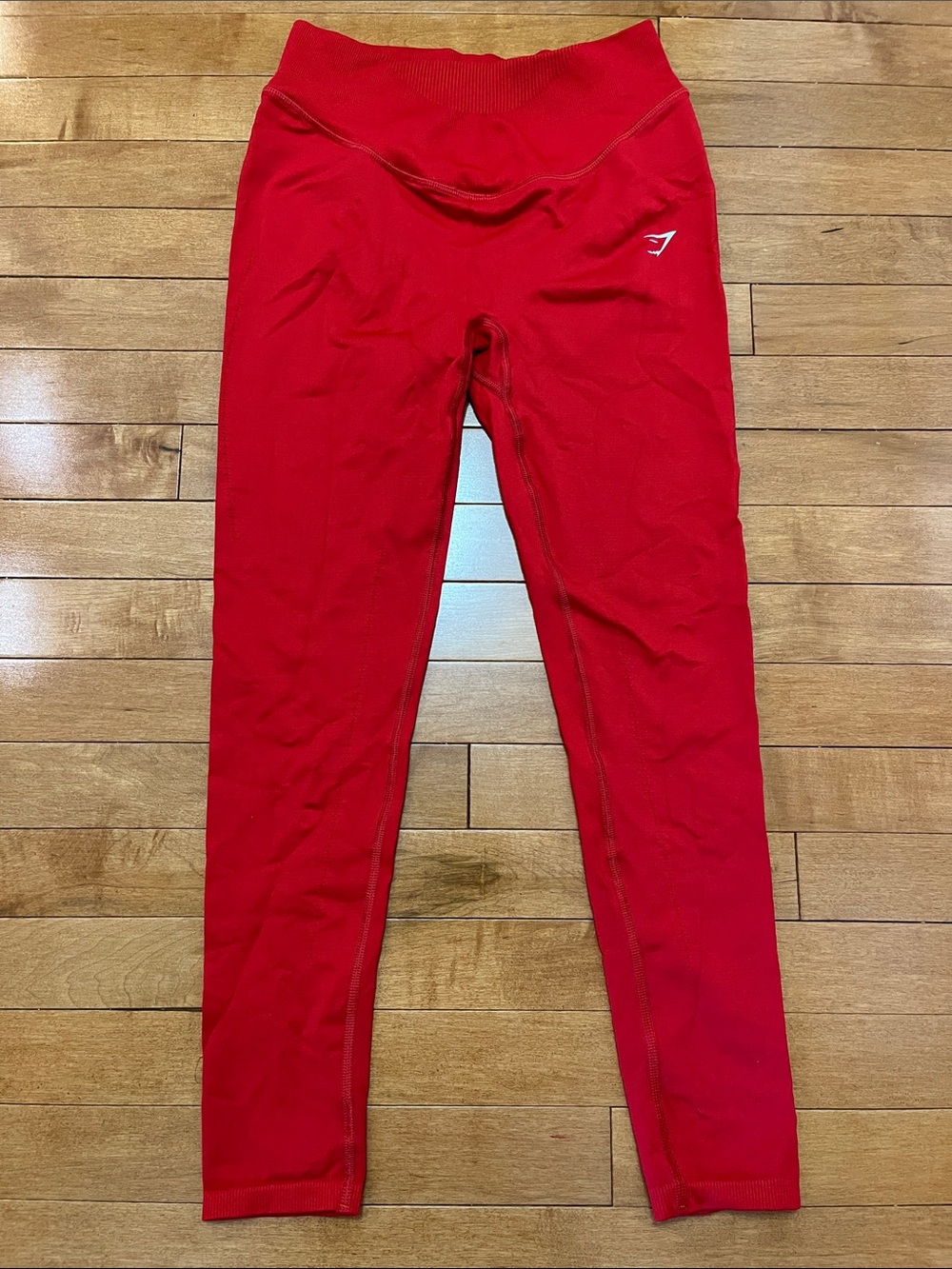 Men's red athletic top with small logo